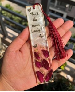 Handmade resin bookmark preserving real dried flowers, showcasing natural petals suspended in clear resin with subtle handcrafted texture.